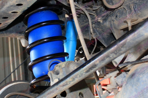 Close up view of some fitted coil helper airbags in side some heavy duty 100 Series coil springs