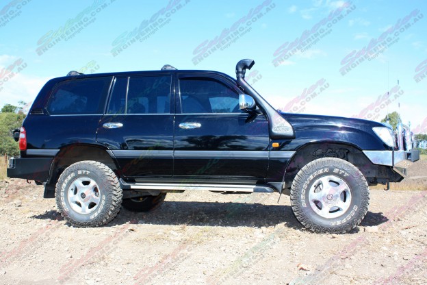 Right side view of a Toyota Landcruiser 100 Series on dirt track fitted with 2" inch lift kit from Superior Engineering
