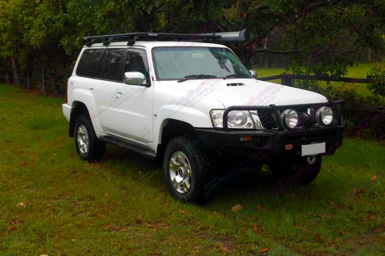 Right side view of a white Nissan Patrol GU Wagon fitted with a 2 inch Airbag Man Coil Helper Kit and Superior lift kit