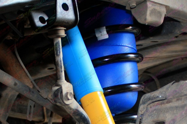 Close up view of Airbag Man coil helpers fitted to the underbody of a  Toyota Landcruiser 100 Series IFS 4x4