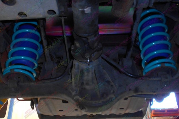Underside view of some Dobinsons springs and Airbag Man coil helper bags fitted to the Nissan Patrol Ute